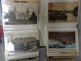 a person holding a stack of old postcards in their hand