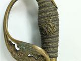 a close up of a sword with a gold handle