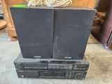 two speakers are stacked on top of each other on a table