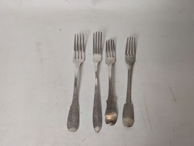 four forks and two spoons sitting on a table