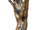 statue of a hand reaching out of a cube on a white background