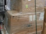 a pile of boxes on a pallet next to a microwave