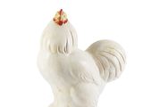a white chicken statue with a red head on a white background