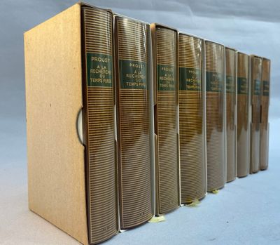 six books are lined up in a row on a white surface