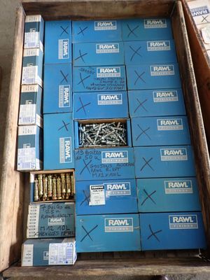 a box of screws sitting on the floor next to a box of screws