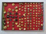 many different types of buttons in a display case