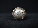 a close up of a silver ball on a black surface