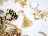a lot of gold and silver jewelry on a white surface