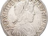 une pièce d'argent portant une tête de femme