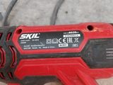 an image of a corded drill is sitting on the ground