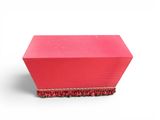 a pink box with a rope around it on a white surface