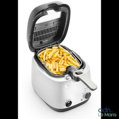 a close up of a fryer with french fries in it