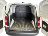 the back of a white van with the door open and a cat in the back