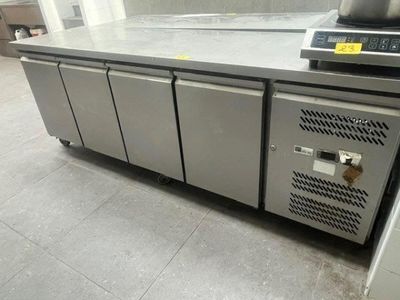 a stainless steel counter with a laptop on top of it