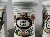 three ceramic jars with different designs on them sitting on a table