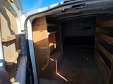 a white van that has a door open and some boxes in the back