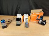 several cell phones are lined up on a table next to a box