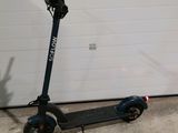 a scooter that is parked in front of a garage door