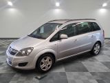 a picture of a silver minivan parked in a garage