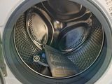a close up of a washing machine with the door open