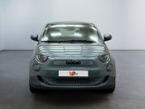 the small car is parked in a large room with a white wall