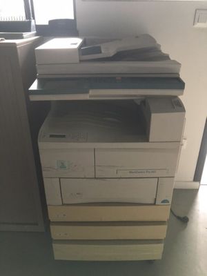 a printer sitting on top of a stack of boxes