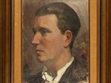 portrait of a man in a suit and bow tie in a gold frame
