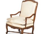 une vieille chaise avec un coussin blanc et une structure en bois