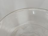 a clear glass bowl with a small amount of liquid in it