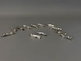 several pieces of silverware are arranged in a circle on a gray surface