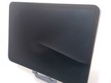 a laptop computer sitting on a stand on a white surface