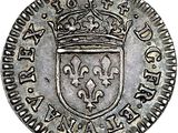 a silver coin with a crown on top of it
