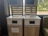 two microwaves sitting on top of each other in a room
