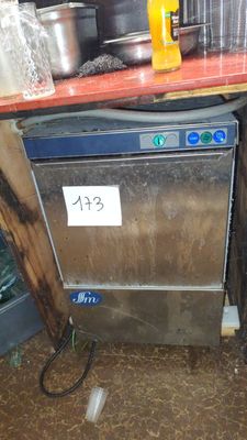 a silver dishwasher sitting on top of a wooden counter