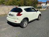 a white car that is parked on the side of the road