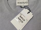 a close up of a sweater with a tag on it