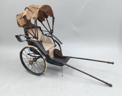 une calèche à l'ancienne, à deux places, avec un auvent à l'arrière