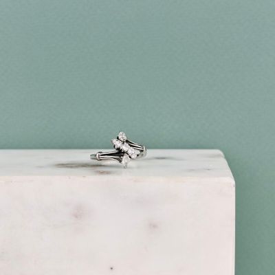 an image of a diamond ring sitting on top of a white marble block