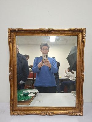 a woman taking a picture of herself in a mirror
