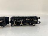 an image of two black train engines sitting side by side on a white surface