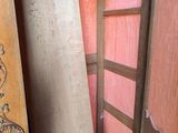 several pieces of wood sit in a room next to a wooden door