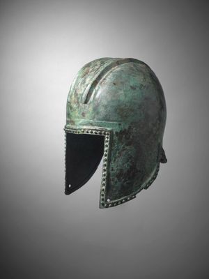 a bronze helmet on a gray background