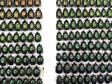two rows of green beetles on the wall next to each other
