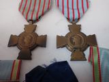 three medals are sitting on a table with ribbons around them