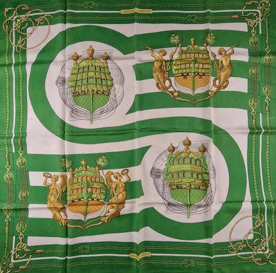 a green and white scarf with two coats of arms on it