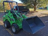 a green tractor that is parked in the parking lot