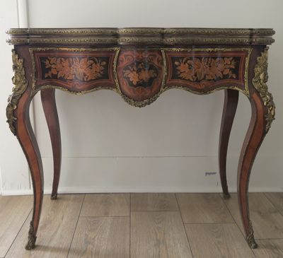 a small wooden table with a mirror on top of it