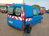 a blue van that is parked in a parking lot