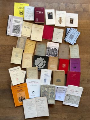 a lot of books that are laying on the floor