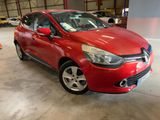 La voiture rouge est garée dans un garage avec d'autres voitures.